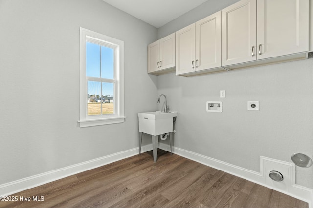 clothes washing area featuring cabinets, hookup for a washing machine, dark hardwood / wood-style flooring, and electric dryer hookup