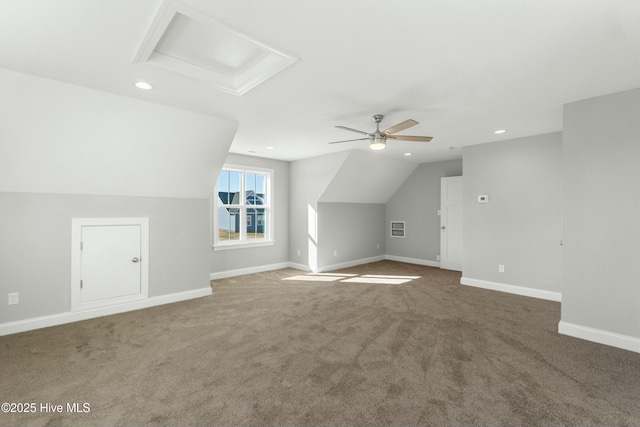 additional living space featuring ceiling fan, lofted ceiling, and dark carpet