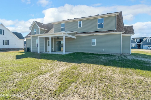 rear view of property featuring a patio, a yard, ceiling fan, and central air condition unit