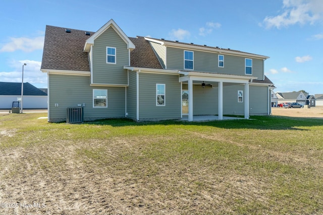 back of house with cooling unit, ceiling fan, and a lawn