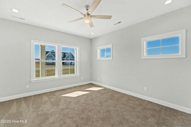 empty room featuring carpet flooring and ceiling fan