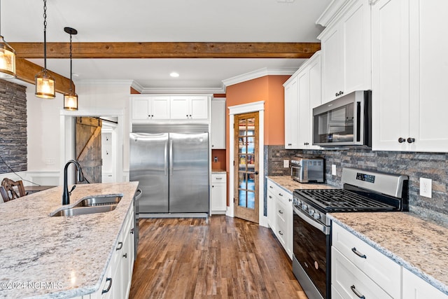 kitchen with appliances with stainless steel finishes, white cabinetry, and sink