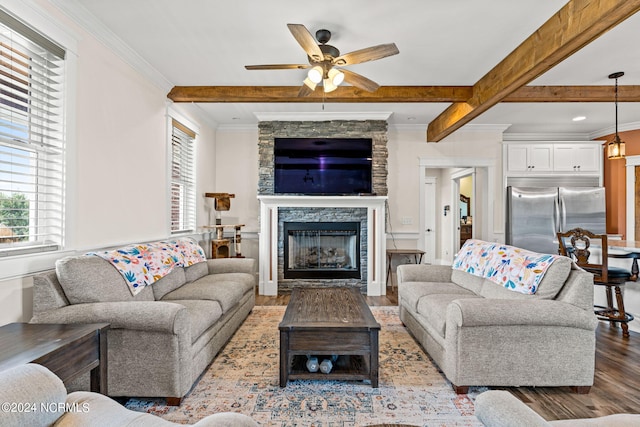 living room with a fireplace, beamed ceiling, crown molding, ceiling fan, and hardwood / wood-style flooring