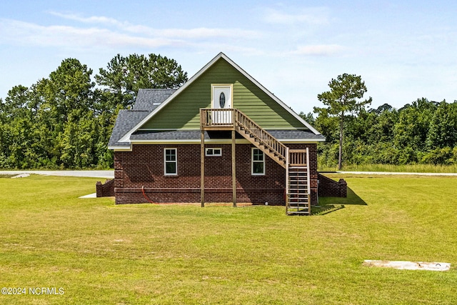 rear view of property with a lawn and central air condition unit