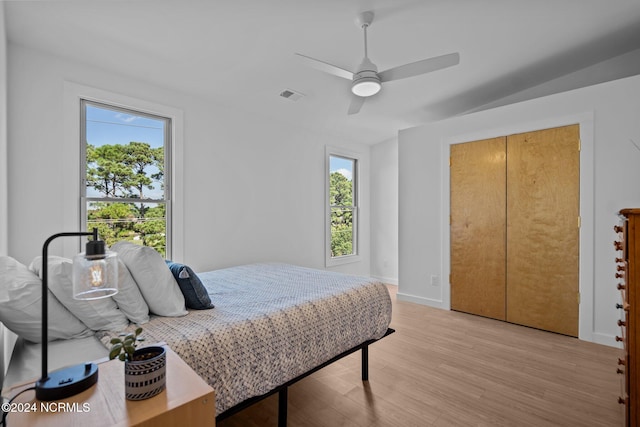 bedroom featuring light wood-type flooring, a closet, and ceiling fan