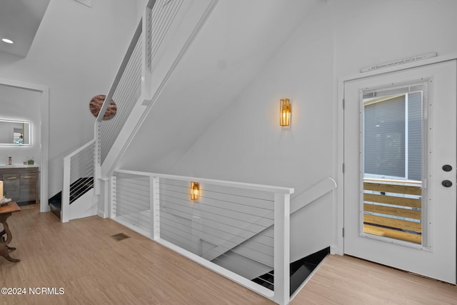 interior space featuring light hardwood / wood-style flooring and lofted ceiling