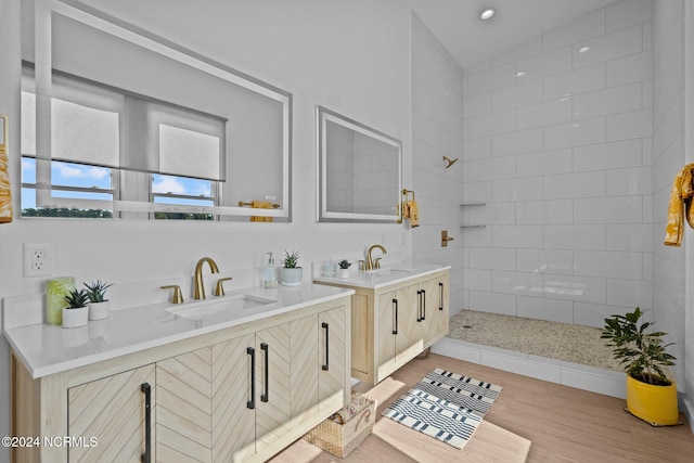 bathroom featuring tiled shower, vanity, and hardwood / wood-style flooring