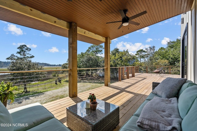 wooden terrace featuring ceiling fan and an outdoor hangout area