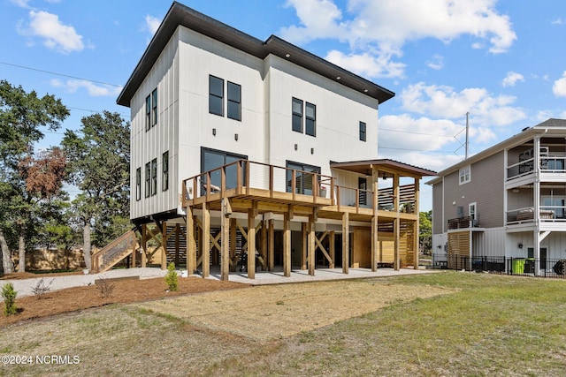 rear view of property with a carport and a yard