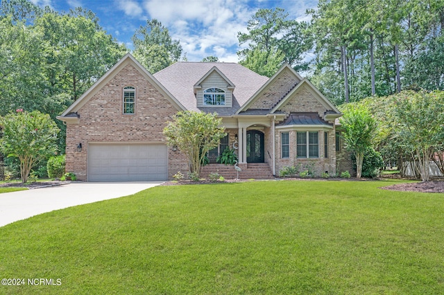 view of front of home featuring a front yard, concrete driveway, brick siding, and an attached garage