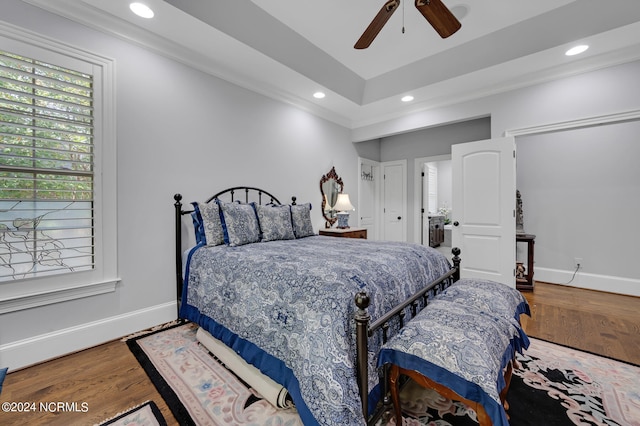 bedroom with baseboards, wood finished floors, and recessed lighting