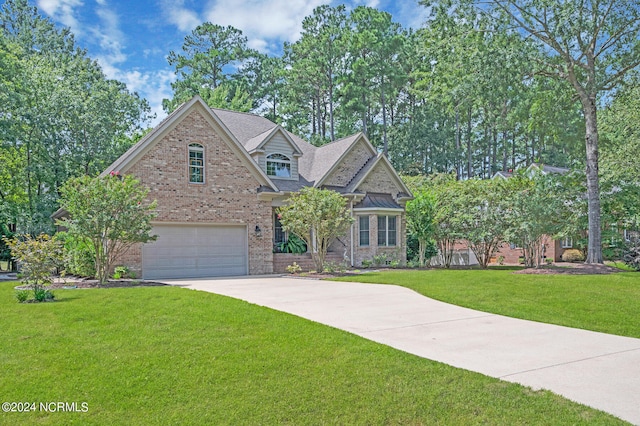 view of front of home featuring a garage and a front yard