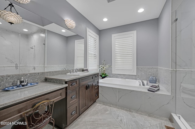 full bathroom featuring marble finish floor, a garden tub, a marble finish shower, recessed lighting, and vanity