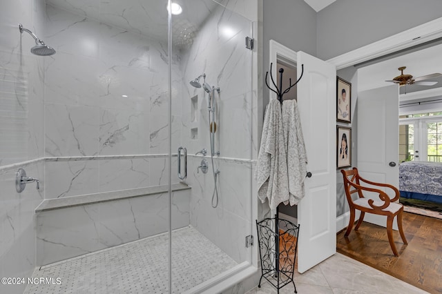 bathroom with ceiling fan, a marble finish shower, and ensuite bathroom