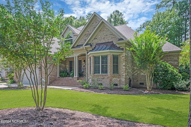 view of front of home featuring brick siding, roof with shingles, crawl space, a garage, and a front lawn