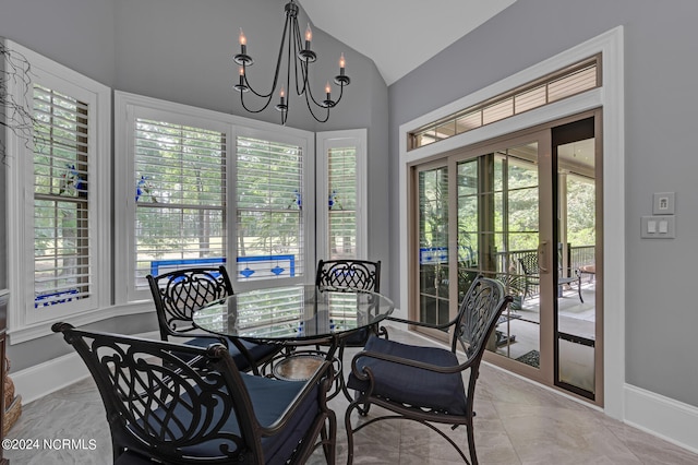 dining area with lofted ceiling, marble finish floor, baseboards, and a notable chandelier