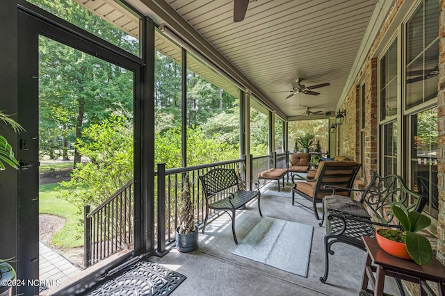 unfurnished sunroom featuring ceiling fan