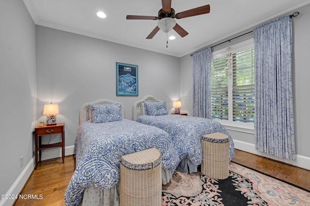 bedroom featuring recessed lighting, crown molding, baseboards, and wood finished floors