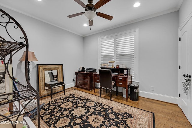 office space with ornamental molding, ceiling fan, baseboards, and wood finished floors