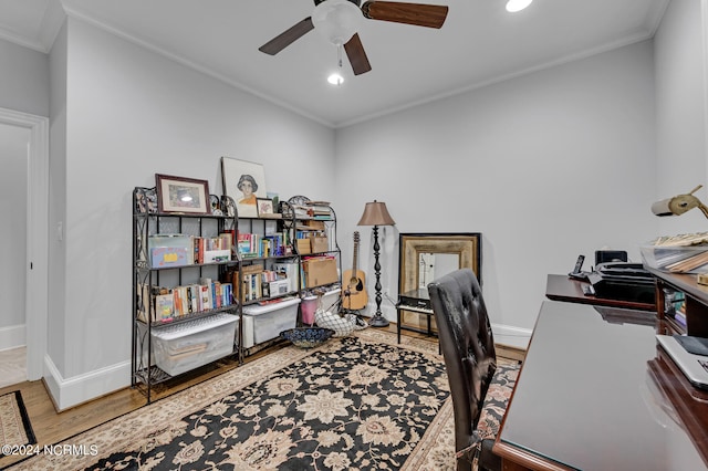 office area featuring a ceiling fan, crown molding, baseboards, and wood finished floors