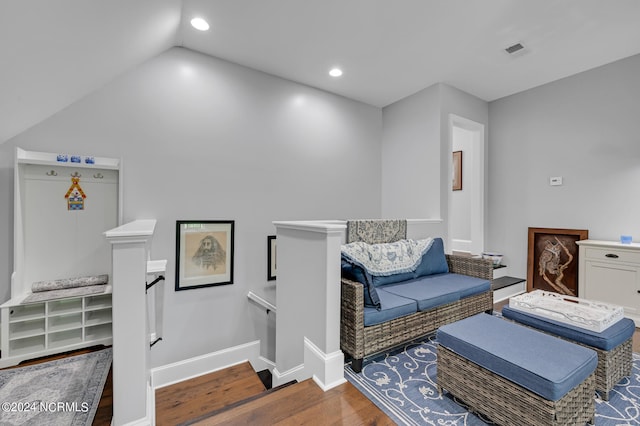 living room featuring baseboards, visible vents, wood finished floors, vaulted ceiling, and recessed lighting