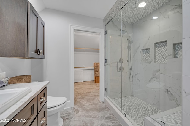 full bath with toilet, marble finish floor, a marble finish shower, and vanity