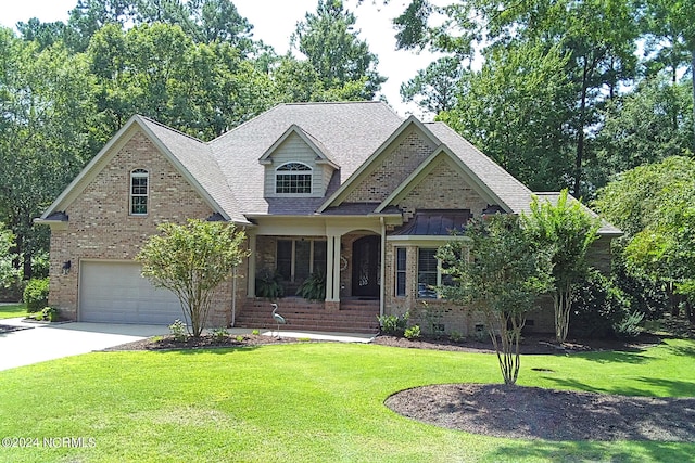 view of front facade with driveway, roof with shingles, an attached garage, a front lawn, and brick siding