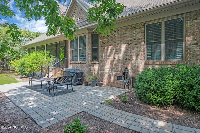 view of patio featuring a sunroom and grilling area