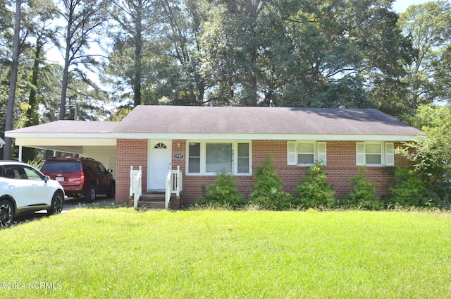 ranch-style house with a carport and a front yard