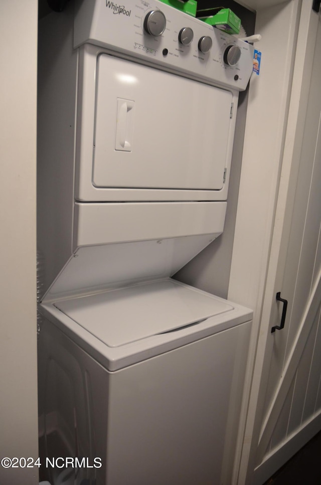 washroom with stacked washer and clothes dryer