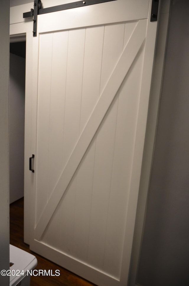 interior space featuring a barn door and wood-type flooring