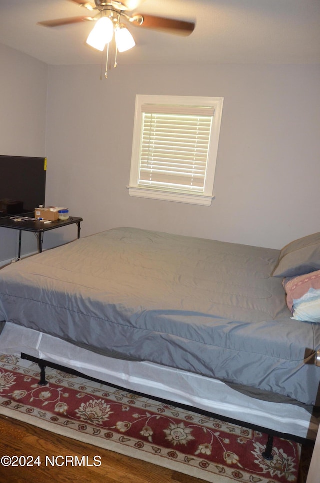 bedroom with ceiling fan and wood-type flooring