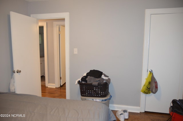 bedroom with dark wood-type flooring