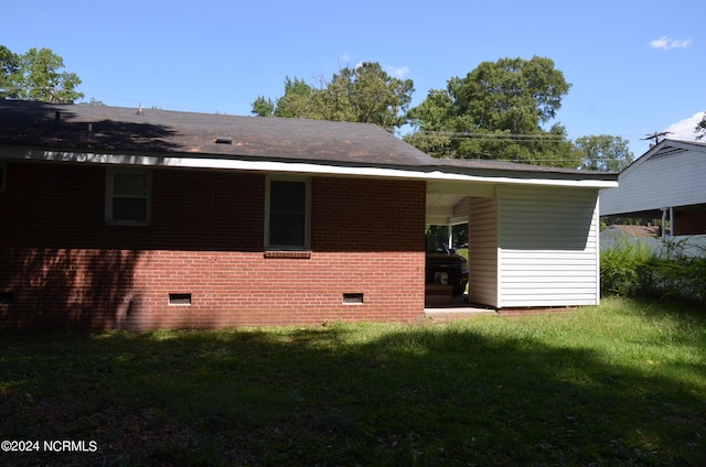 back of house with a yard, brick siding, and crawl space