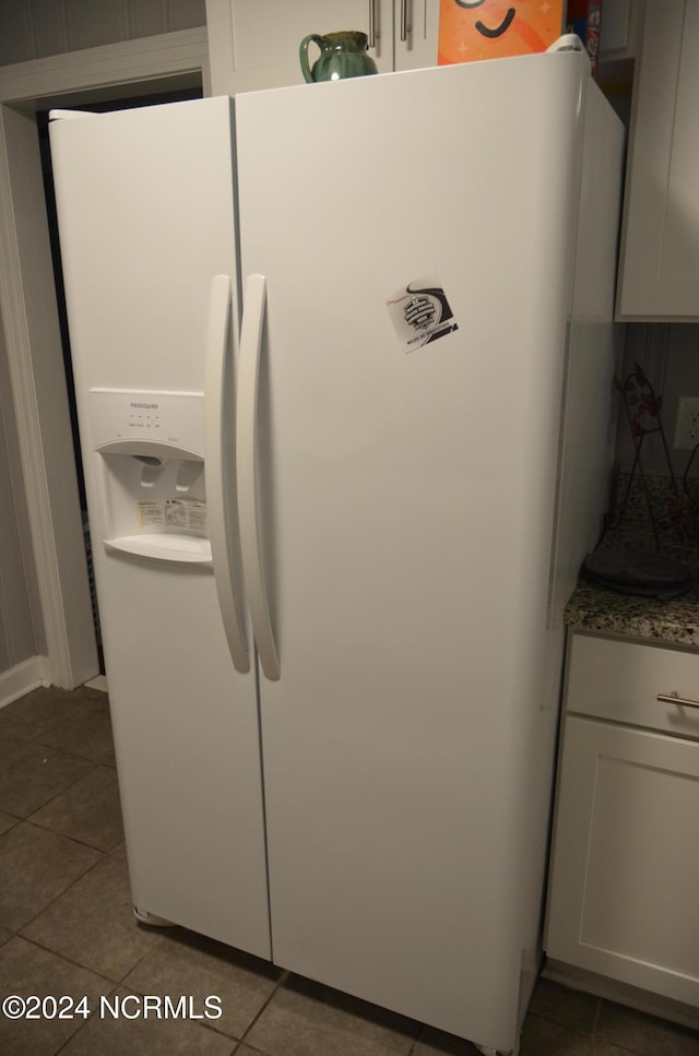 room details featuring white fridge with ice dispenser and white cabinetry