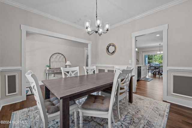 dining room with an inviting chandelier, dark hardwood / wood-style flooring, and crown molding