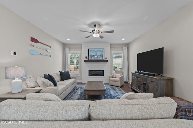 living room with a fireplace, hardwood / wood-style floors, and ceiling fan