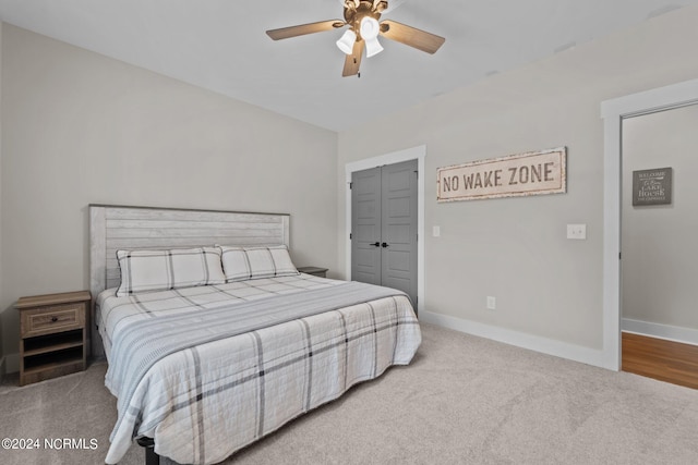 carpeted bedroom with a closet and ceiling fan