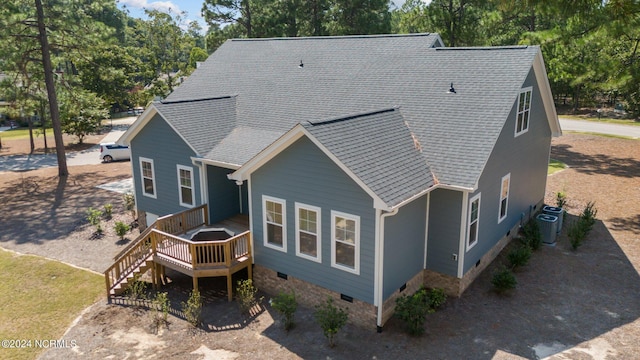 view of front facade with a deck and central air condition unit