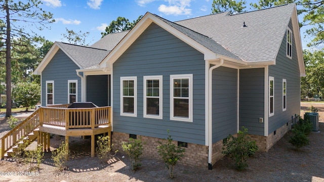 rear view of property featuring a wooden deck and central air condition unit