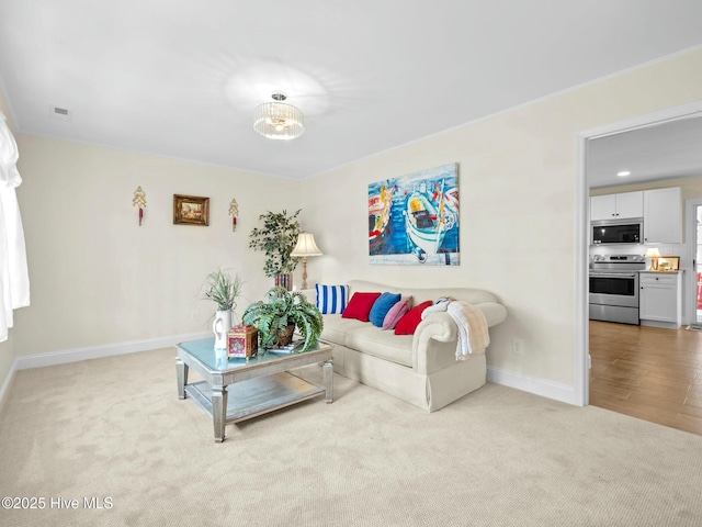 living room featuring carpet flooring, visible vents, and baseboards