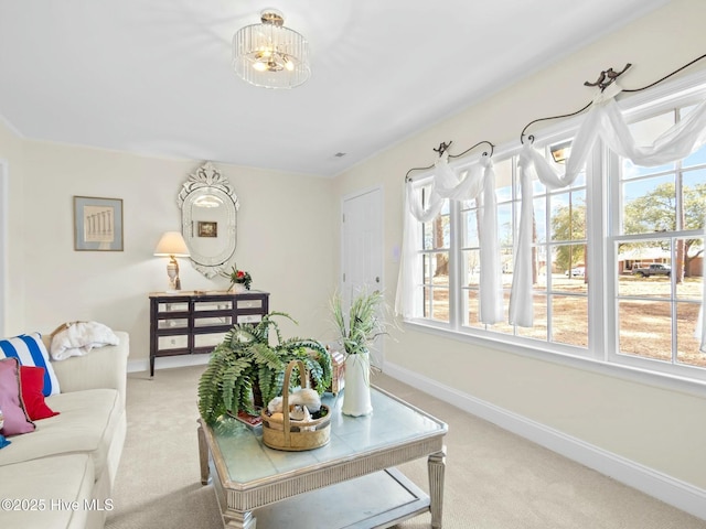 living area with baseboards and light carpet