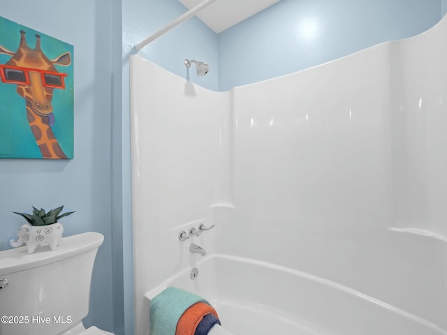 bathroom with shower / bathing tub combination and toilet