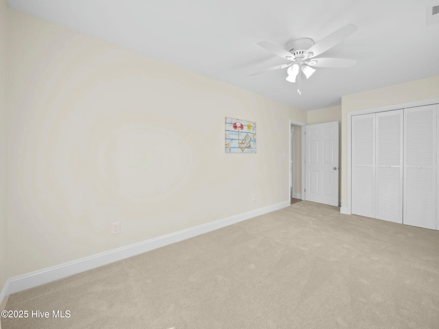 unfurnished bedroom featuring visible vents, a ceiling fan, a closet, carpet flooring, and baseboards