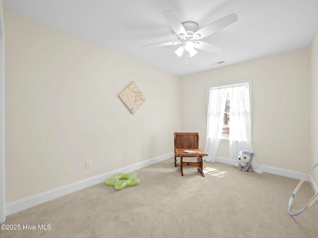 living area with baseboards, visible vents, a ceiling fan, and carpet