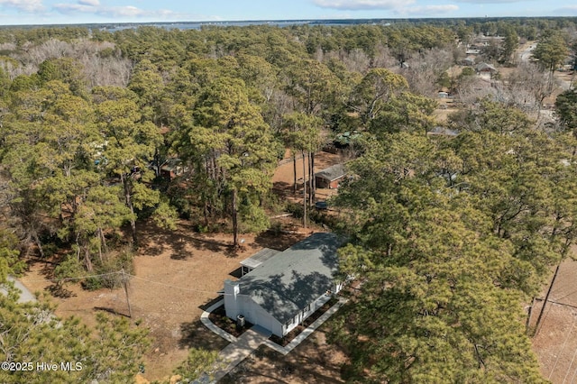 birds eye view of property with a wooded view