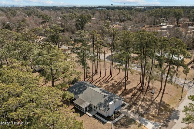 drone / aerial view featuring a wooded view