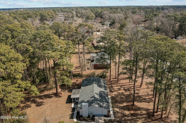 birds eye view of property with a view of trees