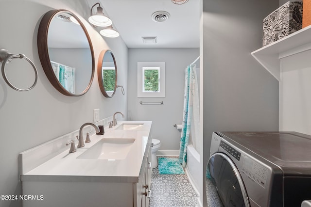 full bathroom featuring shower / tub combo with curtain, dual bowl vanity, tile patterned flooring, washer / clothes dryer, and toilet