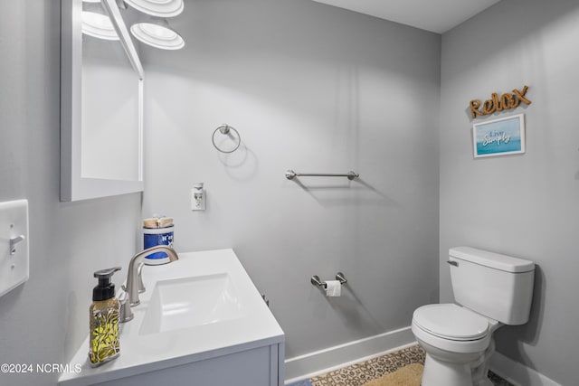 bathroom featuring tile patterned floors, toilet, and vanity